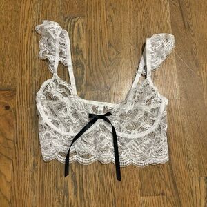 Lacey white lingerie bralette with black bow detail